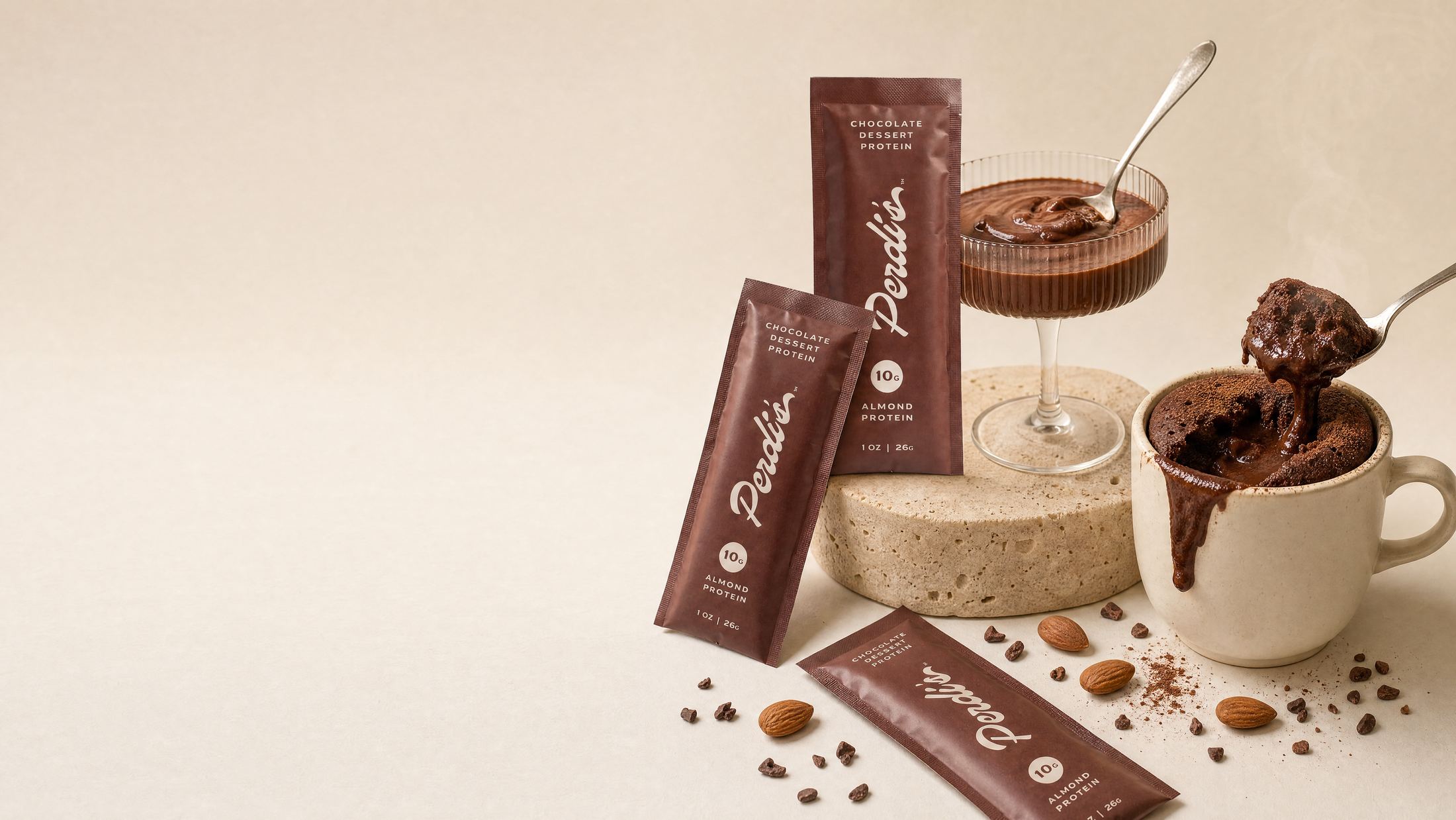 Perdi's packets, a coupe of chocolate pudding, and a warm chocolate mug cake on a cream tabletop