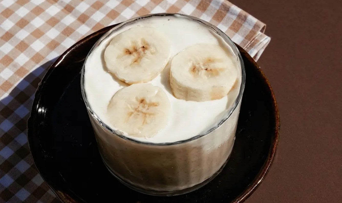 Banana Bread pudding topped with whipped cream and banana slices